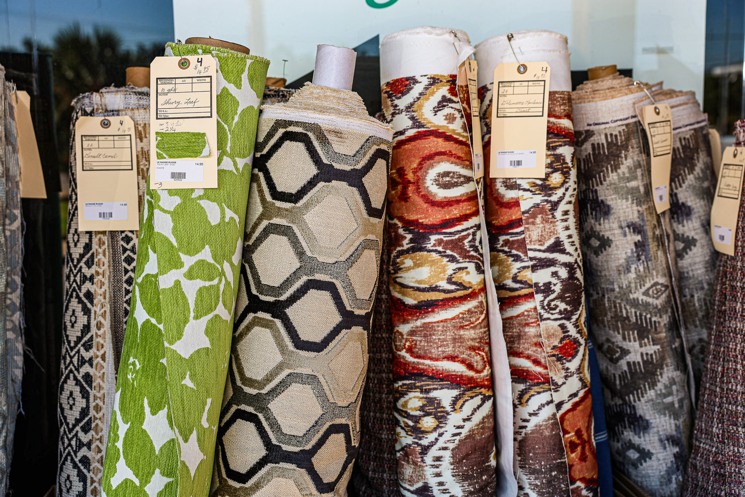 Close-up of upholstery and drapery fabrics at Cowgirls & Lace Fabric Bonanza Sale in Dripping Springs