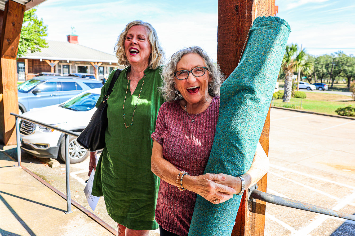 Shoppers browsing designer fabrics during the Cowgirls & Lace Fabric Bonanza Sale in Dripping Springs