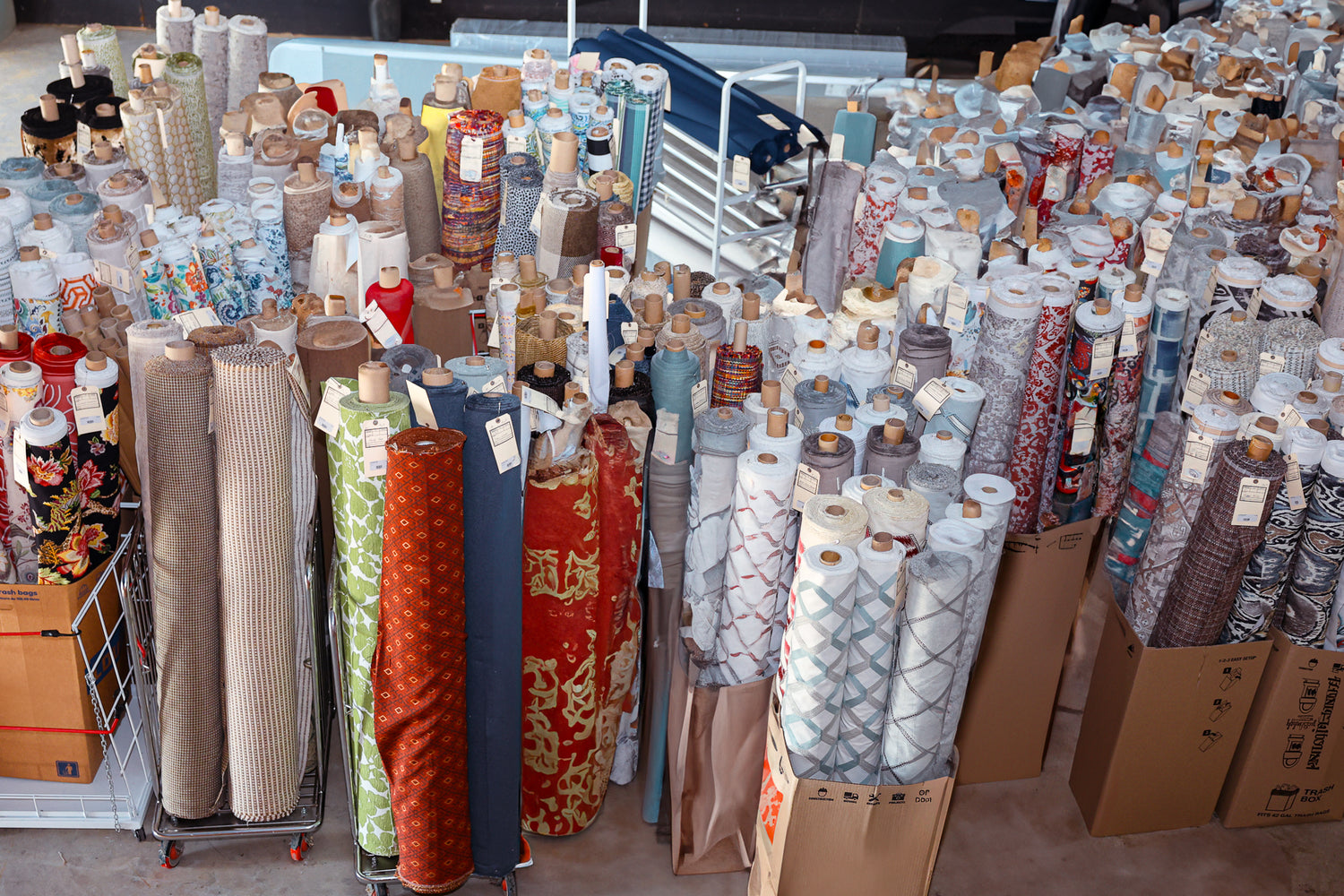 Large collection of fabric rolls in a warehouse setting